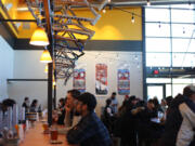 Customers eat at the bar at Hopworks Urban Brewery, under a row of bike frames. The brewery&#039;s culture of sustainability and active living has been part of its success, owner Christian Ettinger said.