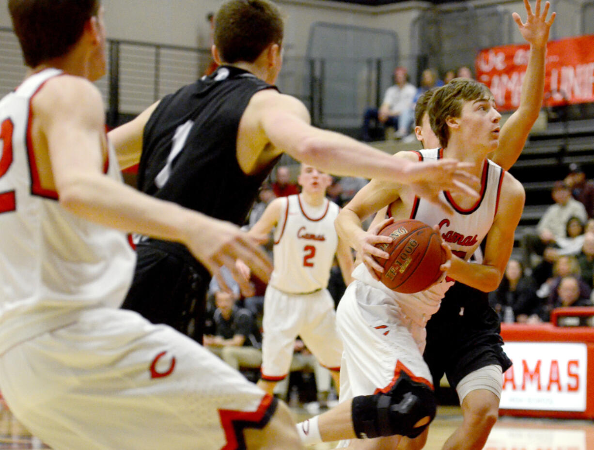 Camas senior Cooper McNatt drives the ball to the hoop against Union at Camas on Wednesday, January 25, 2017. Camas upset Union 50-47.