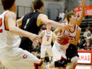 Camas senior Cooper McNatt drives the ball to the hoop against Union at Camas on Wednesday, January 25, 2017. Camas upset Union 50-47.