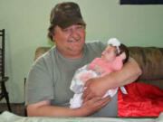 Larry Bremmeyer Sr., photographed here with his granddaughter Aubree Bremmeyer, died Tuesday from complications of pneumonia.