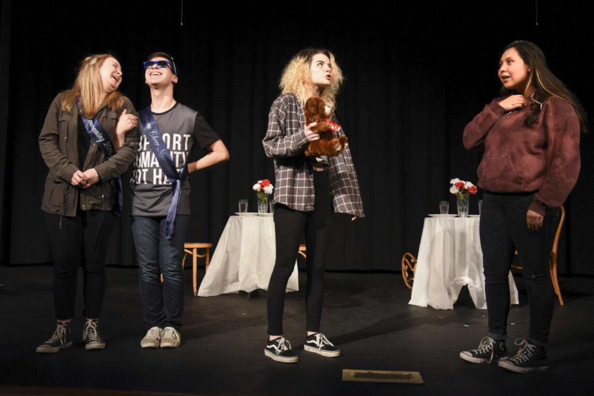 Hockinson High School Theatre Company students, from left, Emma Uusitalo, Alex Elerick, Gina Telio and Arianna Gálvez rehearse their part of the winter play, which will help raise funds for two Hockinson grads who were injured in a car accident earlier this month.