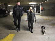 Dan Mitchell, left and Heidi Lee, vice president and president of the Esther Short Neighborhood Association, respectively, and downtown residents and business owners, walk through the Vancouvercenter garage. They and other downtown residents are upset by limited parking in the garage.