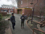 Kylan Johnson, left, and Alex Mickle of Columbia Food Park talk about their vision for the former site of The Urb Garden in downtown Vancouver. The pair aim to place kitchen-equipped shipping containers in the courtyard of the park to serve food.