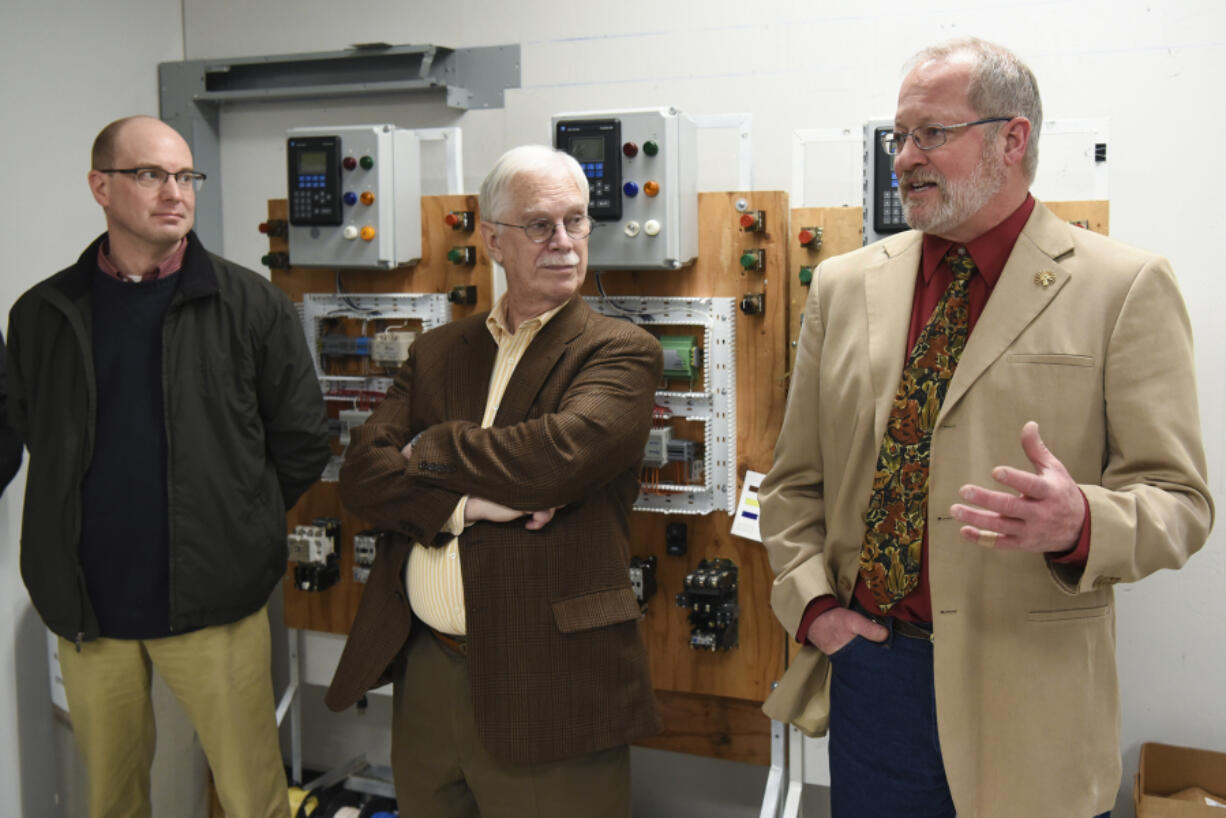 Bob Carroll of IBEW Local No. 48, from right, Port of Vancouver Commissioner Brian Wolfe and port official Ryan Hart discuss workforce challenges Friday at the union&#039;s training center in Portland. The union said multiyear projects help bring skilled workers to the area.