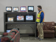 Outlet manager Jason Pickering looks over a selection of televisions for sale at Goodwill Vancouver Outlet on Wednesday morning.