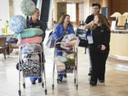 Ashley Burkett, right, laughs with nurses Mandy Westervelt, center, and Rachel Wulf, left, while Ashley&#039;s husband, Aaron Burkett, carries their 3-day-old son, Jackson Burkett, through Legacy Salmon Creek Medical Center on Wednesday. The Burketts were driven home from Legacy Salmon Creek by a volunteer from the Clark County Sheriff&#039;s Search and Rescue because the nearly foot of snow that fell Tuesday evening created difficult road conditions in Vancouver Wednesday.