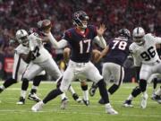 Houston Texans quarterback Brock Osweiler (17) works against the Oakland Raiders during the first half of an AFC Wild Card NFL game Saturday, Jan. 7, 2017, in Houston.