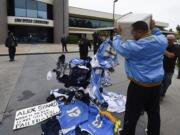 A former Chargers fan dumps memorabilia in front of of the San Diego Chargers headquarters after the team announced that it will move to Los Angeles,  Thursday Jan. 12, 2017, in San Diego.