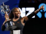 United States' Serena Williams holds her trophy after defeating her sister Venus during the women's singles final at the Australian Open tennis championships in Melbourne, Australia, Saturday, Jan. 28, 2017.