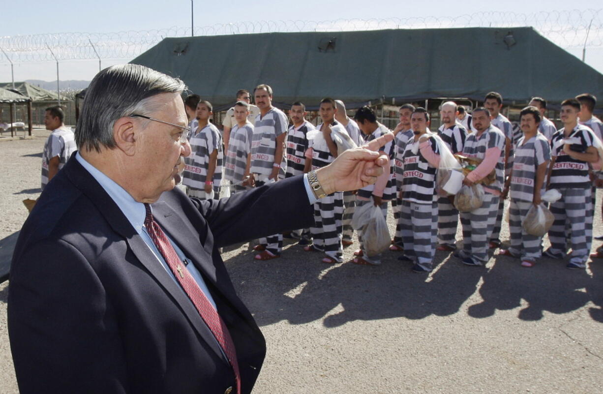 Maricopa County Sheriff Joe Arpaio, left, orders approximately 200 convicted illegal immigrants handcuffed together and moved into a separate area of Tent City, for incarceration until their sentences are served and they are deported to their home countries, in Phoenix.  (AP Photo/Ross D.