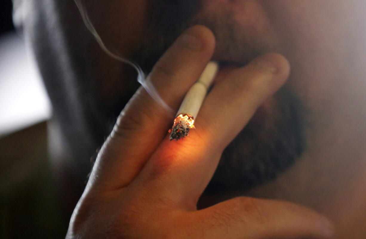 A man smokes a cigarette in New Orleans.