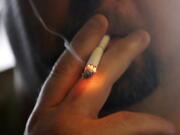 A man smokes a cigarette in New Orleans.