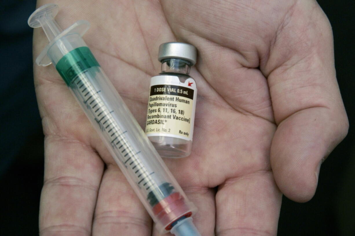 A doctor holds a vial of the human papillomavirus vaccine Gardasil in his Chicago office.