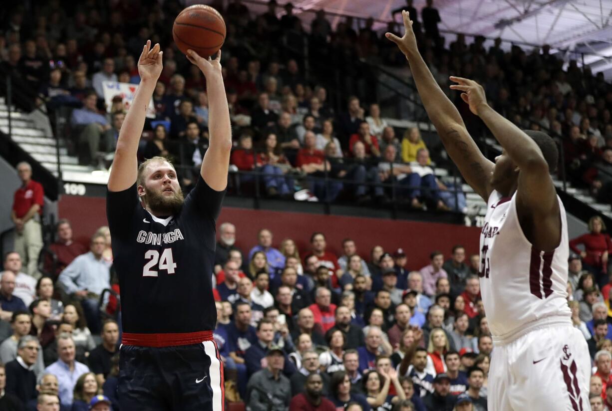 Gonzaga center Przemek Karnowski (24) shoots over Santa Clara center Tony Lewis during the second half of an NCAA college basketball game Thursday, Jan. 19, 2017, in Santa Clara, Calif.