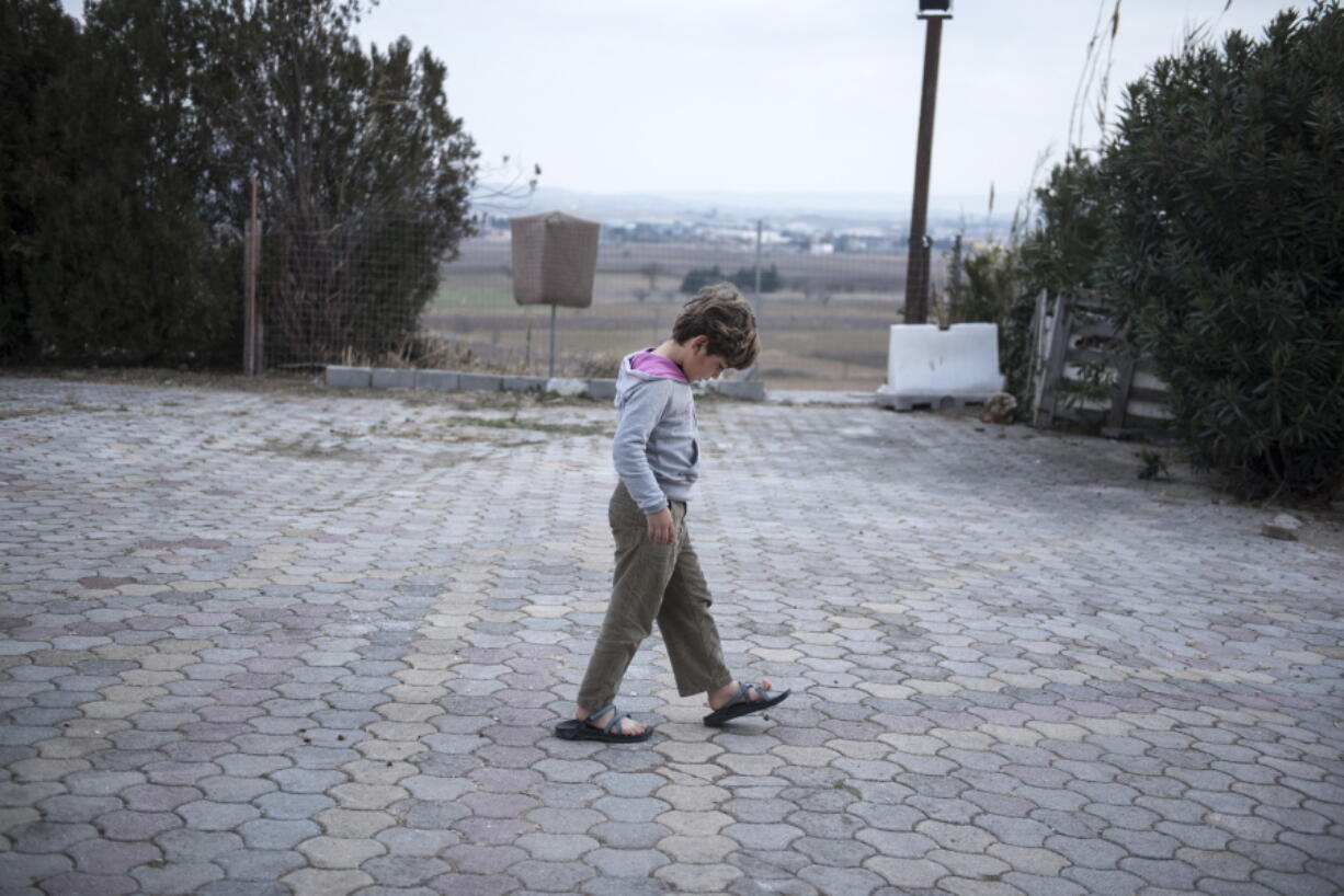 A Yazidi refugee boy walks in the yard of a hotel in the northern Greek village of Agios Athanasios, near Thessaloniki city. Portugal has offered to take in several hundred of the 2,500 Yazidi refugees living in Greece, arguing that the mistreated religious minority merits special protection.