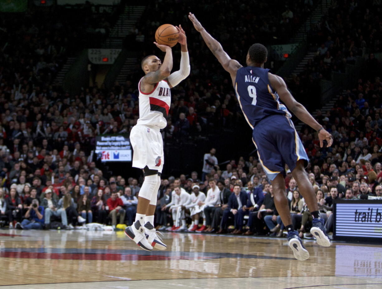 Portland Trail Blazers guard Damian Lillard, left, shoots a 3-point basket in front of Memphis Grizzlies guard Tony Allen during the second half of an NBA basketball game in Portland, Ore., Friday, Jan. 27, 2017. The Trail Blazers won 112-109.