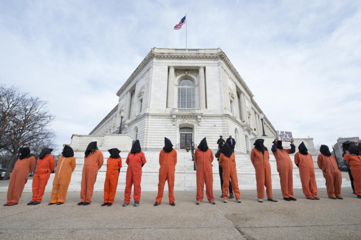 Protesters with Witness Against Torture rally Jan. 11 in front of the Russell Senate Office Building in Washington, marking the 15th anniversary of the first Afghan prisoners&#039; arriving at the Guantanamo Bay detention center and calling for the closing of the prison.