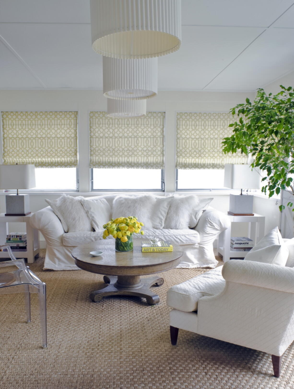 Dramatic touches of yellow bring warmth and energy to contrast with the crisp whites and soft, natural wood tones in this relaxing sunroom, designed by New York-based interior designer Young Huh. (John M.