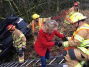 Firefighters rescued a woman and her three children who were trapped in a minivan after it went down an embankment Monday morning.