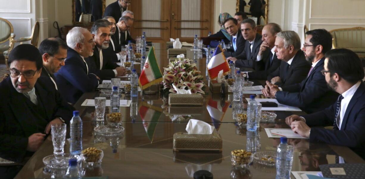 Iranian Foreign Minister Mohammad Javad Zarif, third left, his French counterpart Jean-Marc Ayrault, third right, and their delegations hold of talks in Tehran, Iran, on Tuesday.