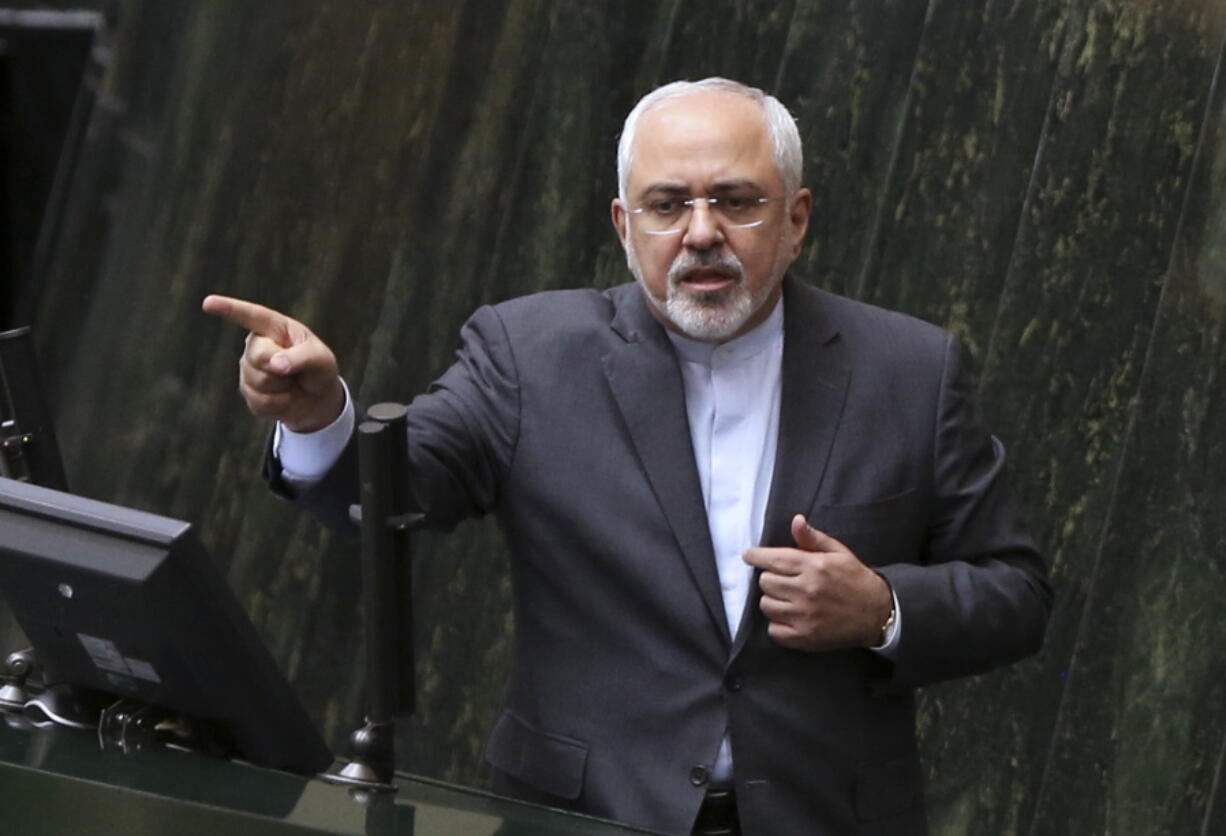 In this file photo dated Sunday, Oct. 2, 2016, Iranian Foreign Minister Mohammad Javad Zarif answers questions from lawmakers in an open session of parliament in Tehran, Iran, explaining the nuclear deal with world powers.  Iran is to receive a huge shipment of natural uranium from Russia to compensate it for exporting tons of reactor coolant, according to unidentified Iranian diplomats Monday Jan. 9, in a move approved to keep Tehran committed to a landmark nuclear pact.