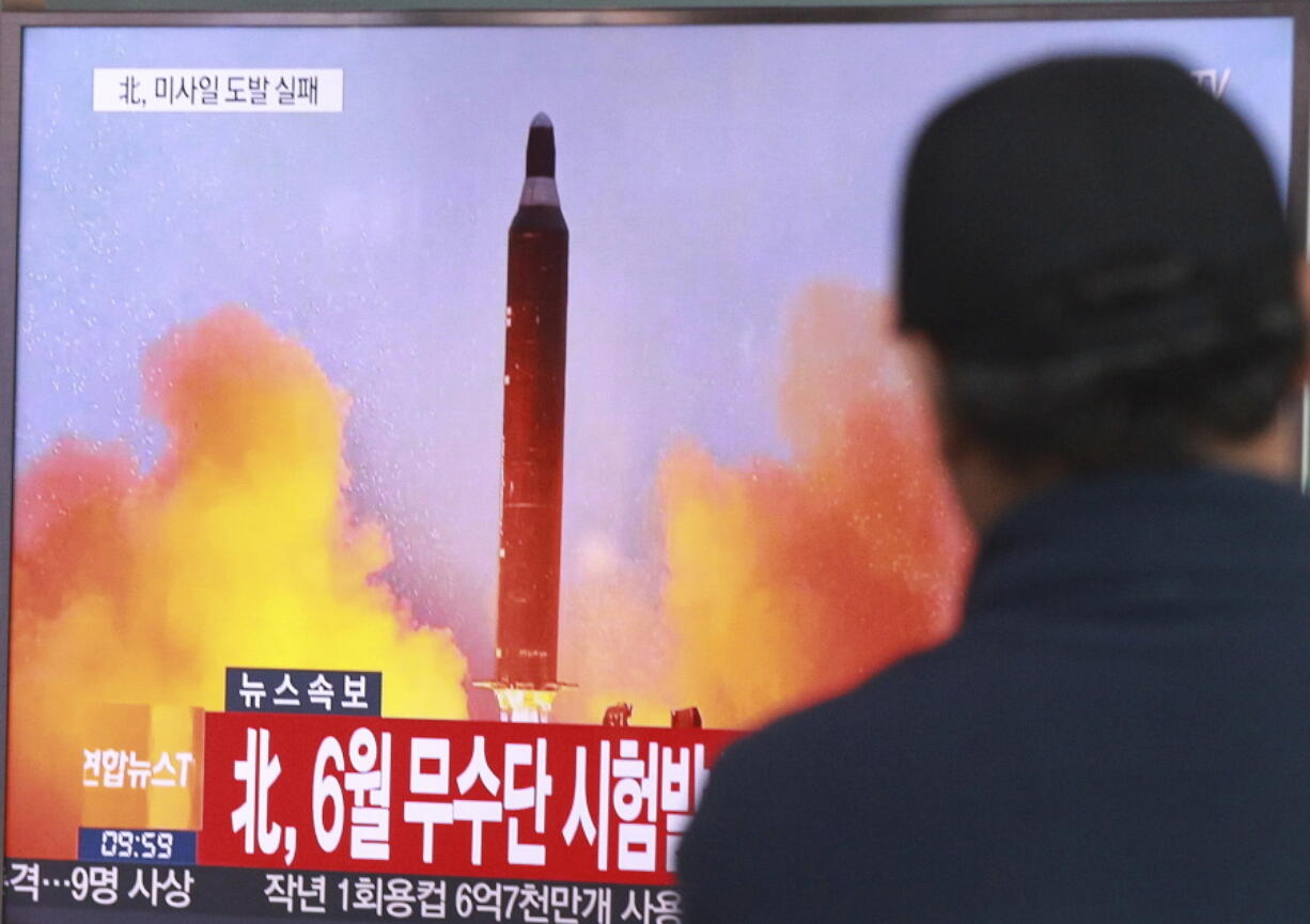 A man watches a TV news program showing a file image of a missile launch conducted by North Korea, at the Seoul Railway Station in Seoul, South Korea.