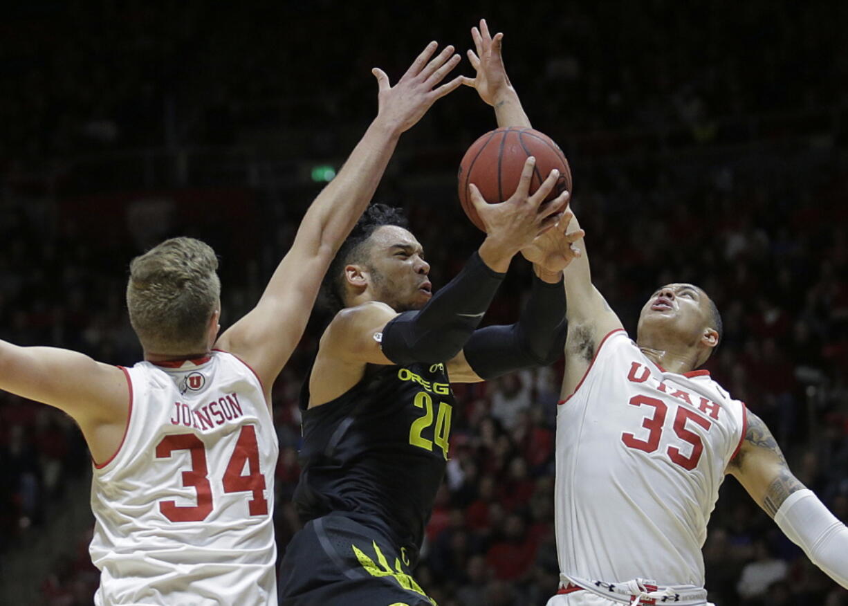 Oregon forward Dillon Brooks (24) goes to the basket as Utah&#039;s Jayce Johnson (34) and Kyle Kuzma (35) defend during the first half  Thursday in Salt Lake City. The No. 10-ranked Ducks won 73-67.