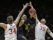 Oregon forward Dillon Brooks (24) goes to the basket as Utah&#039;s Jayce Johnson (34) and Kyle Kuzma (35) defend during the first half  Thursday in Salt Lake City. The No. 10-ranked Ducks won 73-67.