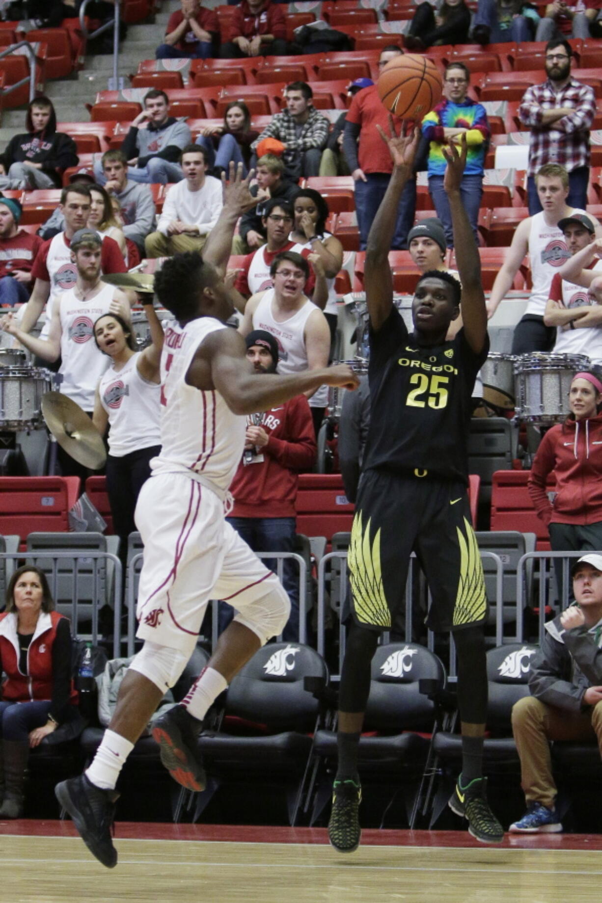 Oregon forward Chris Boucher (25) shoots while defended by Washington State guard Ike Iroegbu during the second half of an NCAA college basketball game in Pullman, Wash., Saturday, Jan. 7, 2017.