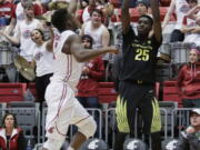 Oregon forward Chris Boucher (25) shoots while defended by Washington State guard Ike Iroegbu during the second half of an NCAA college basketball game in Pullman, Wash., Saturday, Jan. 7, 2017.