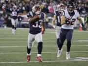 New England Patriots running back Dion Lewis (33) runs ahead of Houston Texans linebacker Brian Peters (52) for a touchdown during the first half of an NFL divisional playoff football game, Saturday, Jan. 14, 2017, in Foxborough, Mass.