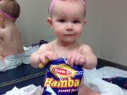 Estelle holds a bag of peanut snacks in her pediatrician&#039;s office at age 9 months in Columbus, Ohio. Most babies should start eating peanut-containing foods well before their first birthday, say guidelines released Thursday that aim to protect high-risk tots and other youngsters, too, from developing the dangerous food allergy.