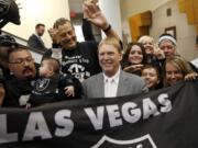 Oakland Raiders owner Mark Davis, center, meets with Raiders fans after speaking at a meeting of the Southern Nevada Tourism Infrastructure Committee in Las Vegas in April. The Raiders have filed paperwork to move to Las Vegas. Clark County Commission Chairman Steve Sisolak told The Associated Press on Thursday, Jan. 19, 2017,  that he spoke with the Raiders.