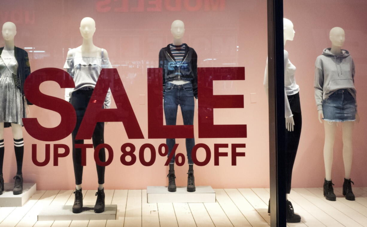 An H&amp;M store window advertises a sale in New York.