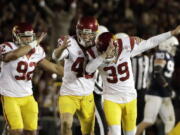 Southern California place kicker Matt Boermeester, right, celebrates after the game winning field goal against Penn State during the second half of the Rose Bowl NCAA college football game Monday, Jan. 2, 2017, in Pasadena, Calif.