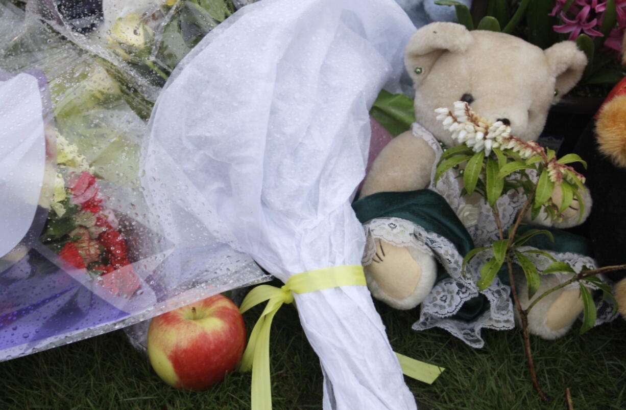 An apple, stuffed animals, and flowers are among the items placed at a growing memorial to slain teacher Jennifer Paulson across the street from Birney Elementary School in Tacoma. When the economy tanks, school shootings rise, unlike other violent crime, a new study finds.  (AP Photo/Ted S.