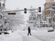 Vancouver resident Tony Nardy strolls through downtown under cold, snowy conditions Wednesday morning, Jan. 11, 2017.