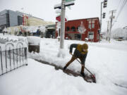 Vinnie Coco, owner of Vinnie's Pizza, clears a pathway to his restaurant in downtown Vancouver on Wednesday morning, Jan. 11, 2017.