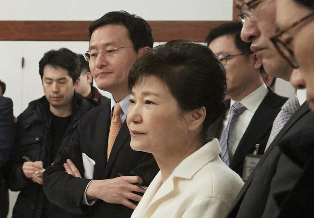 Impeached South Korean President Park Geun-hye, center, listens to a reporter&#039;s question during a meeting with a selected group of reporters Sunday at the presidential house in Seoul, South Korea. Park vehemently rejected accusations Sunday that she conspired with a longtime friend to extort money and favors from companies, accusing her opponents of framing her.