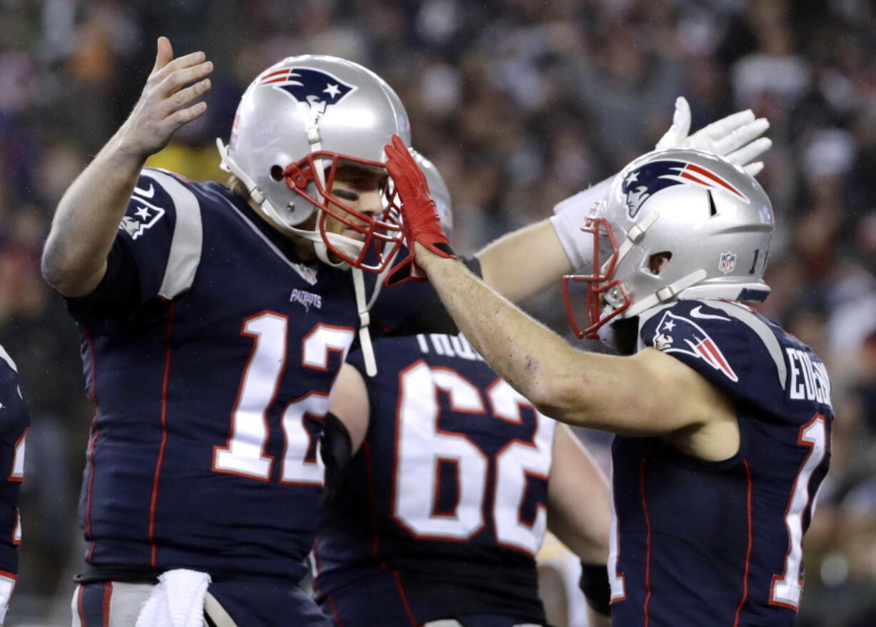 New England Patriots quarterback Tom Brady (12) celebrates with wide receiver Julian Edelman (11) after throwing a touchdown pass during the second half of the AFC championship NFL football game against the Pittsburgh Steelers, Sunday, Jan. 22, 2017, in Foxborough, Mass.