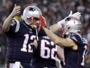 New England Patriots quarterback Tom Brady (12) celebrates with wide receiver Julian Edelman (11) after throwing a touchdown pass during the second half of the AFC championship NFL football game against the Pittsburgh Steelers, Sunday, Jan. 22, 2017, in Foxborough, Mass.