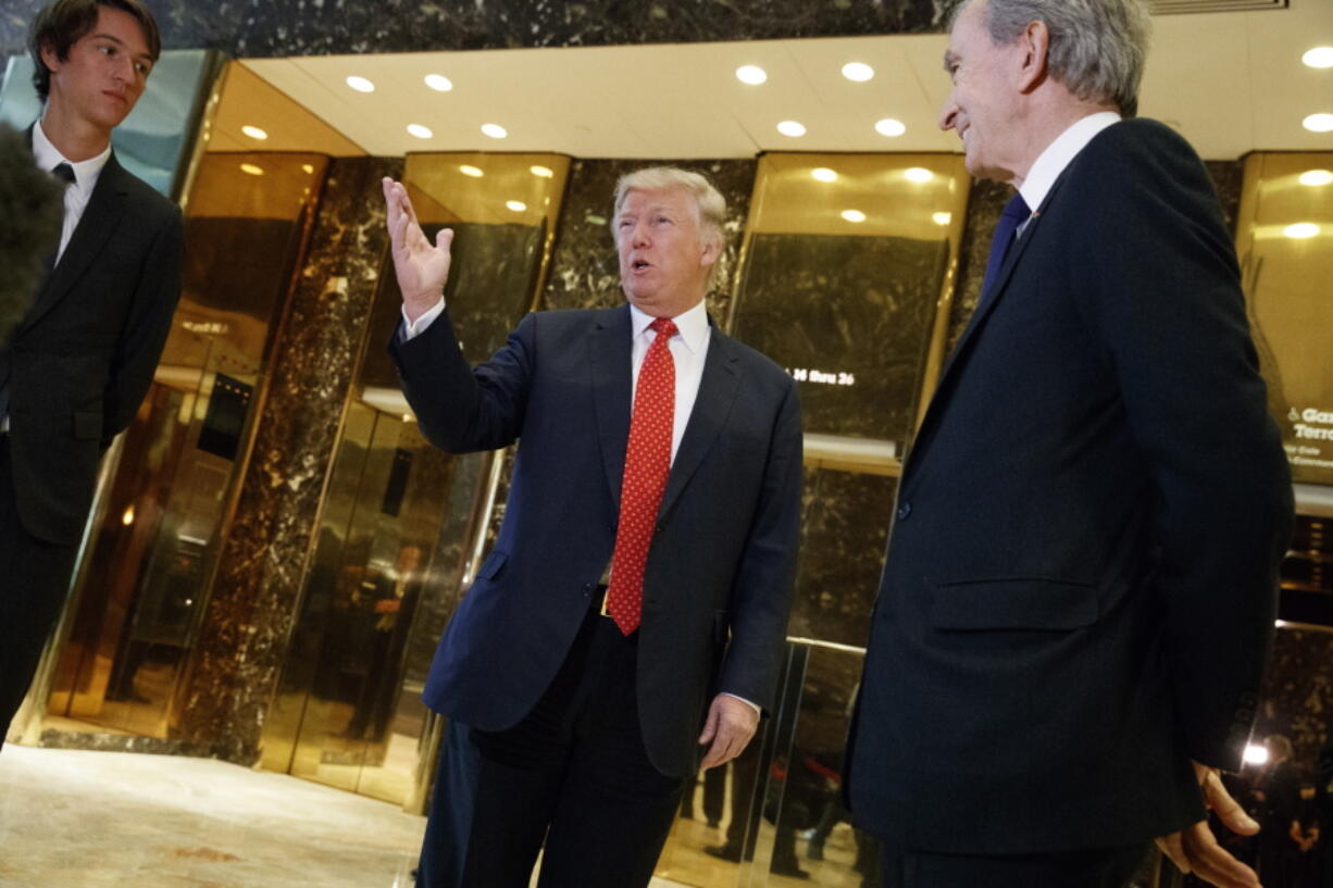 President-elect Donald Trump, accompanied by French businessman Bernard Arnault, speaks with reporters Monday after a meeting at Trump Tower in New York.