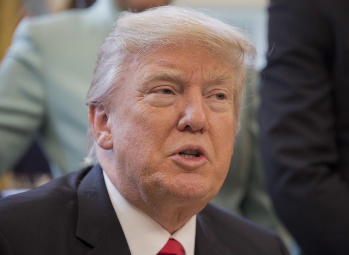 President Donald Trump speaks in the Oval Office of the White House in Washington, on Monday before signing an executive order. Trump's order is aimed at significantly cutting regulations. White House officials are calling the directive a &quot;one in, two out&quot; plan. It requires government agencies requesting a new regulations to identify two regulations they will cut from their own departments.