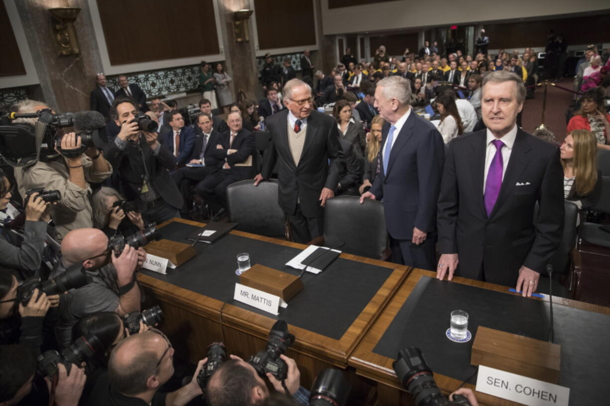 Defense Secretary-designate James Mattis, center, flanked by former Georgia Sen. Sam Nunn, left, and former Maine Sen. and former Defense Secretary William Cohen, arrives on Capitol Hill in Washington on Thursday to testify at his confirmation hearing before the Senate Armed Services Committee.  (AP Photo/J.