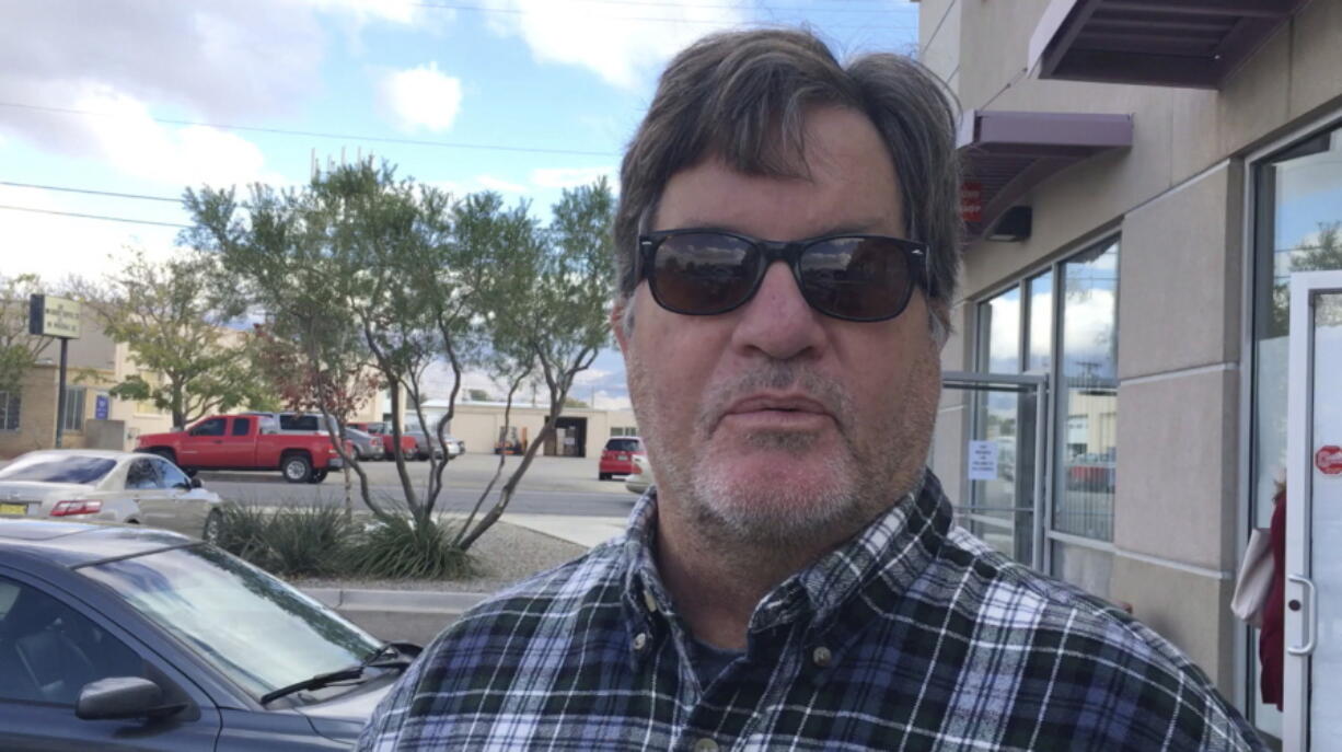 John Barnes, 60, of Albuquerque, N.M., speaks outside an early Albuquerque voting site about voting for Republican Donald Trump because he believed Democrat Hillary Clinton &quot;was a security risk&quot; and &quot;a liar.&quot; The retired Air Force member believes Trump will bring the country together like he ran his businesses. Barnes likes what he sees so far from President Trump regarding the border wall and infrastructure proposals.