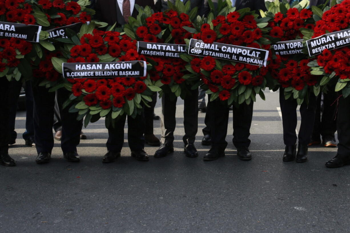 Members of Turkey&#039;s main opposition Republican People&#039;s Party arrive Wednesday with floral tributes for the victims of the New Year&#039;s day attack, near the Reina nightclub, in Istanbul.