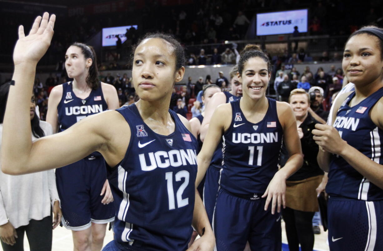 Connecticut guard Saniya Chong (12) and her teammates wave to fans after an NCAA college basketball game against SMU, Saturday, Jan. 14, 2017, in Dallas. Connecticut won 88-48, their 91st straight win.