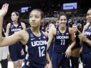 Connecticut guard Saniya Chong (12) and her teammates wave to fans after an NCAA college basketball game against SMU, Saturday, Jan. 14, 2017, in Dallas. Connecticut won 88-48, their 91st straight win.