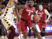 Washington State forward Robert Franks, an Evergreen High School grad, drives past Arizona State forward Ramon Vila (33) during the first half Sunday in Tempe, Ariz. Franks scored six points and made three of four field goals.