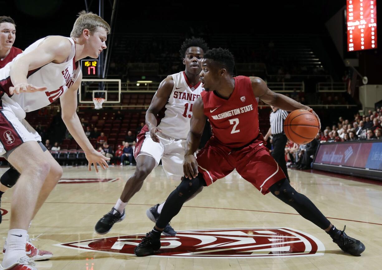 Washington State guard Ike Iroegbu (2) is defended by Stanford's Marcus Allen (15) and Michael Humphrey, left, during the first half of an NCAA college basketball game Thursday, Jan. 12, 2017, in Stanford, Calif.